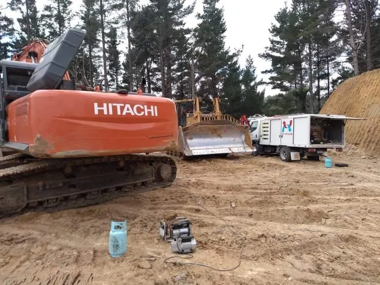 Hitachi excavator air conditioning repair on a job site